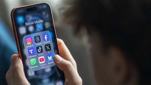 BATH, UNITED KINGDOM - MARCH 29: In this photo illustration a 14-year-old boy holds an iPhone screen displaying various social media and messaging apps on March 29, 2026 in Bath, England. On top row left to right, the logo of social media platform Instagram is seen beside that of Meta’s Threads and Facebook. On the middle row from left is the logo of Donald Trump's Truth Social app, next to the logo of social media app TikTok and the logo of Elon Musk’s US online social media and social networking site 'X' (formerly known as Twitter). Along the bottom row, left to right is the messaging service WhatsApp, the logo for online video sharing and social media platform YouTube and the logo for the Bluesky app. In the UK, a ban on social media for under-16s has been backed by the House of Lords following the Australian law which aims to stop children under 16 from having social media accounts and social media platforms, including TikTok, Facebook, Snapchat, Reddit, X, formerly Twitter, and Instagram potentially being be fined for preventing children younger than 16 from having social media accounts. (Photo by Anna Barclay/Getty Images) BATH, UNITED KINGDOM - MARCH 29: In this photo illustration a 14-year-old boy holds an iPhone screen displaying various social media and messaging apps on March 29, 2026 in Bath, England. On top row left to right, the logo of social media platform Instagram is seen beside that of Meta’s Threads and Facebook. On the middle row from left is the logo of Donald Trump's Truth Social app, next to the logo of social media app TikTok and the logo of Elon Musk’s US online social media and social networking site 'X' (formerly known as Twitter). Along the bottom row, left to right is the messaging service WhatsApp, the logo for online video sharing and social media platform YouTube and the logo for the Bluesky app. In the UK, a ban on social media for under-16s has been backed by the House of Lords following the Australian law which aims to stop children under 16 from having social media accounts and social media platforms, including TikTok, Facebook, Snapchat, Reddit, X, formerly Twitter, and Instagram potentially being be fined for preventing children younger than 16 from having social media accounts. (Photo by Anna Barclay/Getty Images)