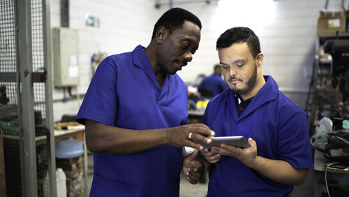 Colleagues using digital tablet and working in industry Colleagues using digital tablet and working in industry