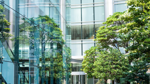 Sky and clouds reflected in a modern building glass facade